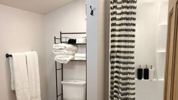 Shower, rainfall showerhead, hair dryer, towels