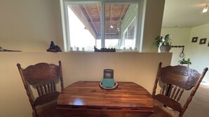 A dining table with four chairs, a window above, and a view of the outdoors. - Mountain Vista Retreat, Excellent Views, Private entrance and living area (Palmer)
