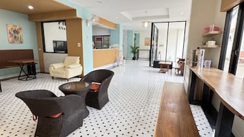 A lobby with seating areas, a reception desk, and a bar.