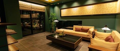 A modern living room with a sofa, coffee table, and a fireplace.