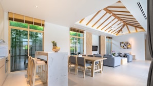 A modern interior with a dining area, kitchen, and living space.
