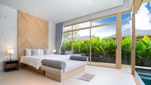 A modern bedroom with a large bed, a nightstand, and a view of a swimming pool.