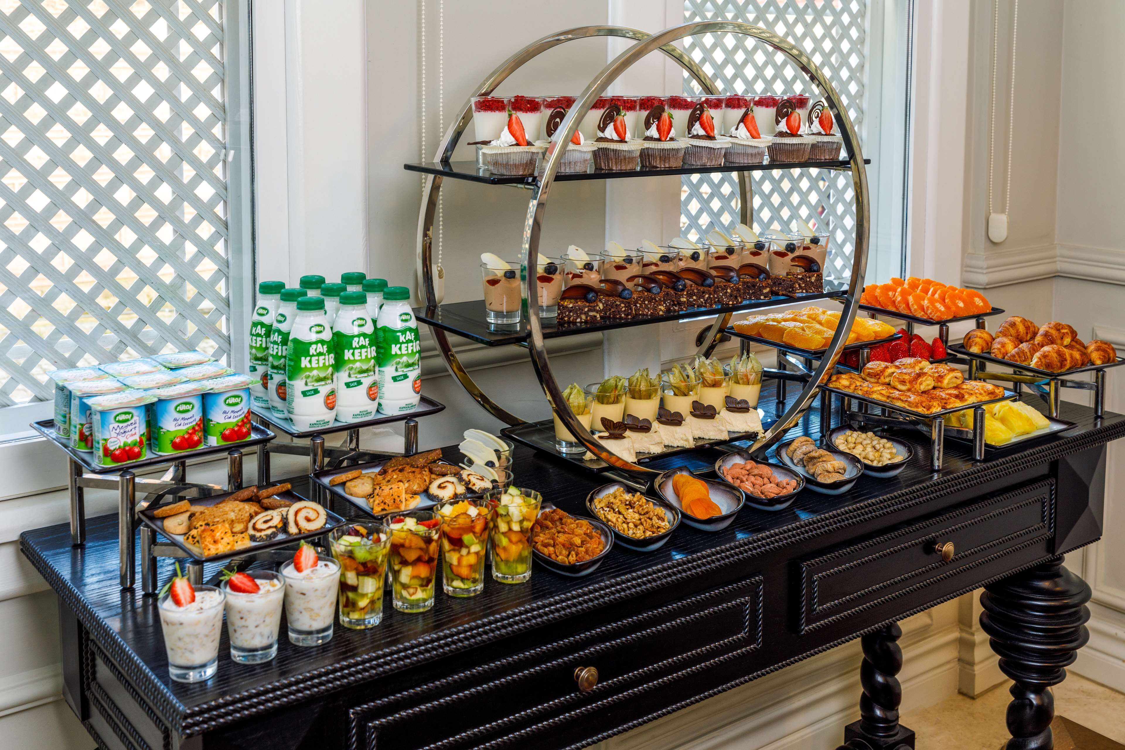 A buffet table with various food items and beverages.