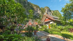 A resort with multiple buildings surrounded by lush greenery and a mountainous backdrop. - The Scene Cliff View Villas (Krabi)