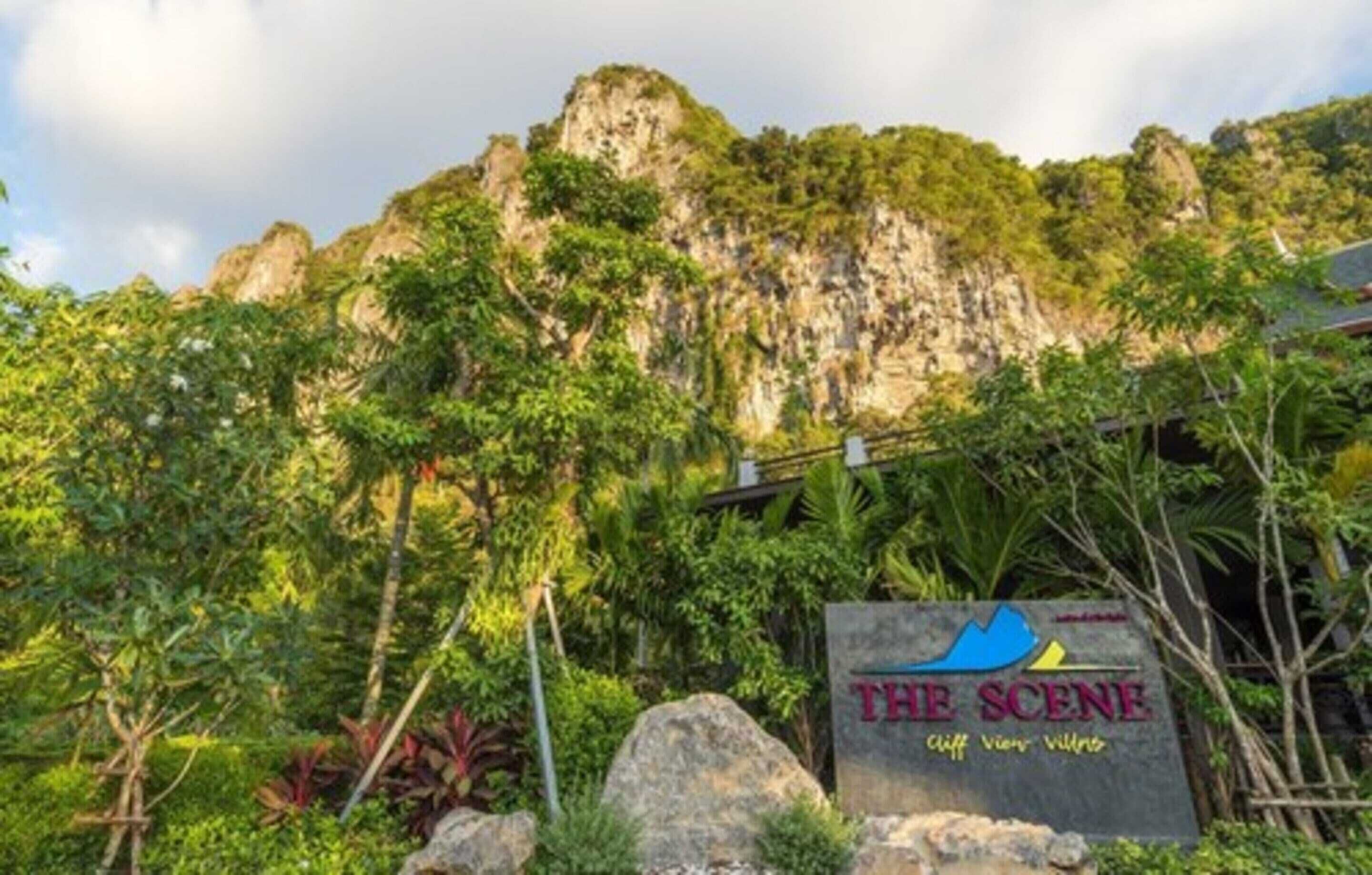 A sign for 'The Scene Cliff View Villa' with a mountainous backdrop.