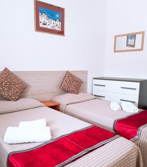 Twin Room, Shared Bathroom | In-room safe, desk, blackout drapes, iron/ironing board