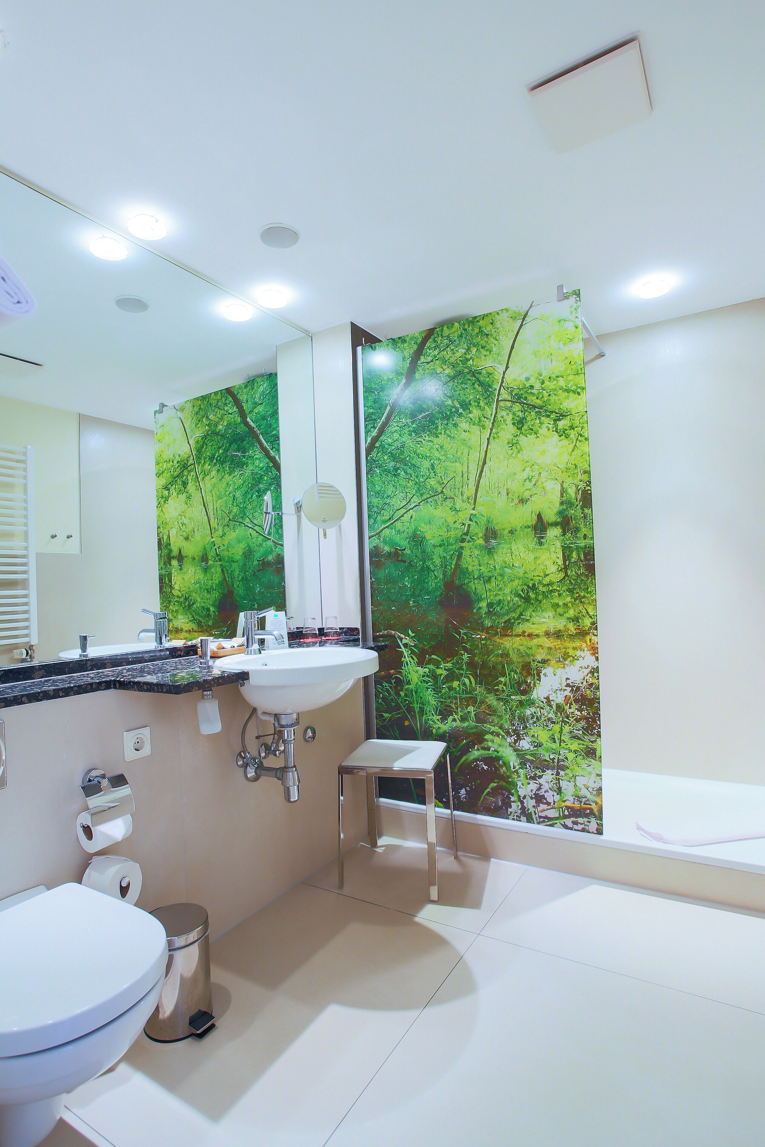 A bathroom with a sink, toilet, and shower.