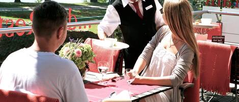 A table set for three people with a view of a lake.