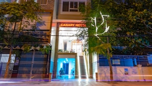 A multi-story hotel with a prominent sign reading "CANARY HOTEL." - Canary Nha Trang Hotel (Bac Nha Trang)