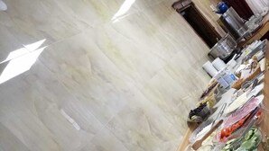 A kitchen area with a marble floor, various food items, and kitchenware. - Azizoglu Malkoc Hotel (Diyarbakir)