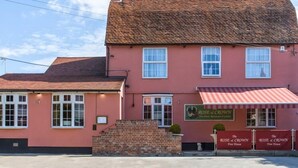 A pink building with a red roof, two windows, and a sign that reads "Rose & Crown Free House". - The Rose & Crown Free House (Clacton-on-Sea)