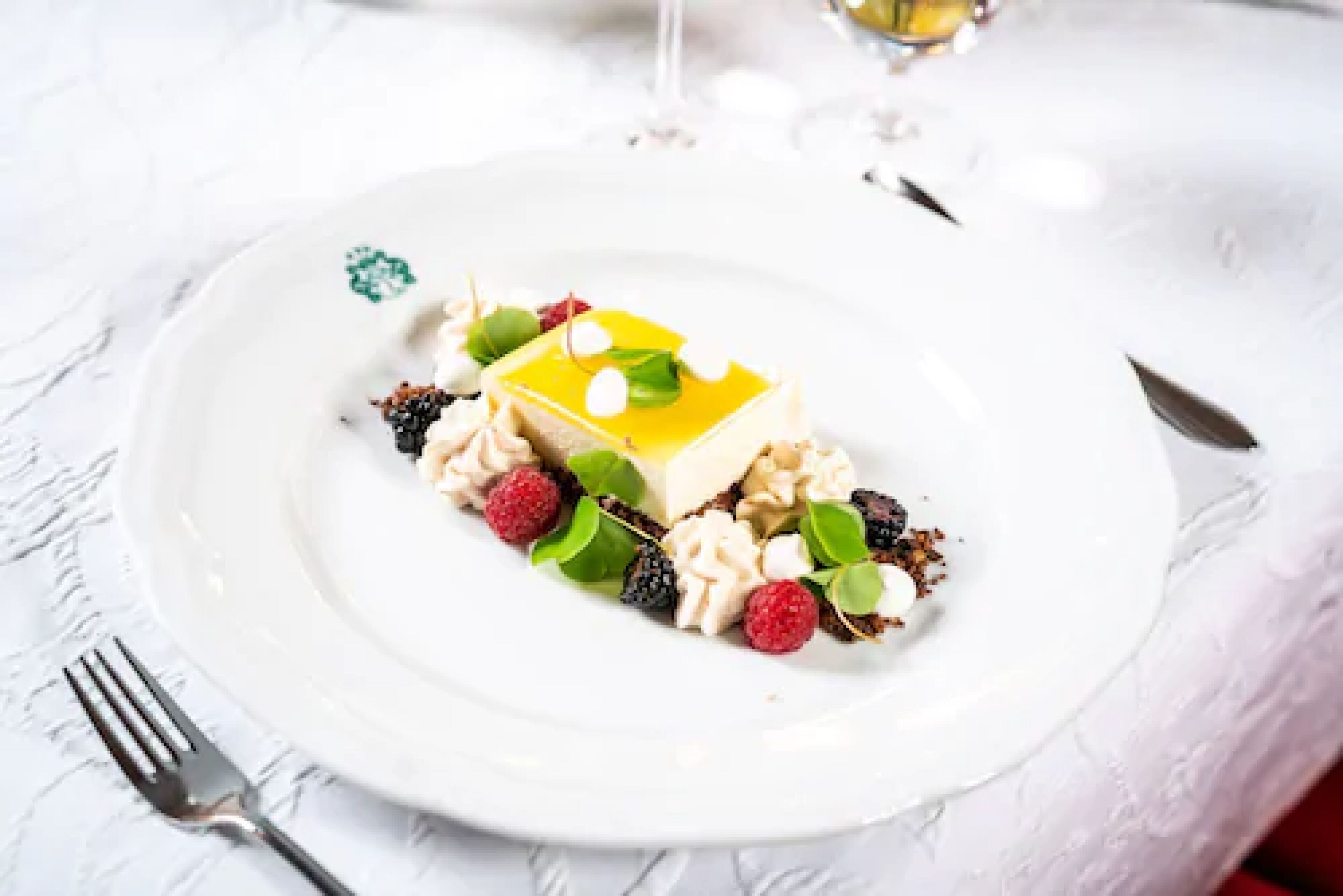 A dessert on a white plate with a fork beside it.