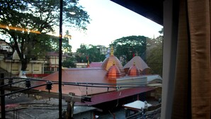 A view of a building with multiple domed structures, a red roof, and a visible staircase leading to an upper level.