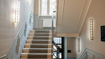 A grand staircase with a handrail, leading to an upper floor.