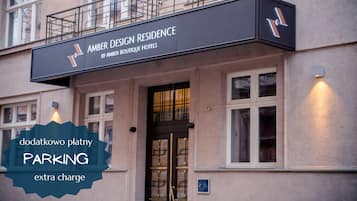 A hotel entrance with a sign reading "Amber Design Residence by Amber Boutique Hotels".