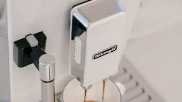 A coffee machine with a digital display and a portafilter.
