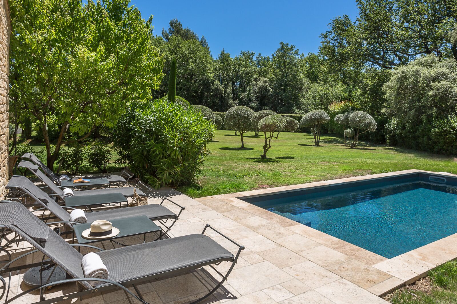 A poolside area with lounge chairs and a swimming pool.