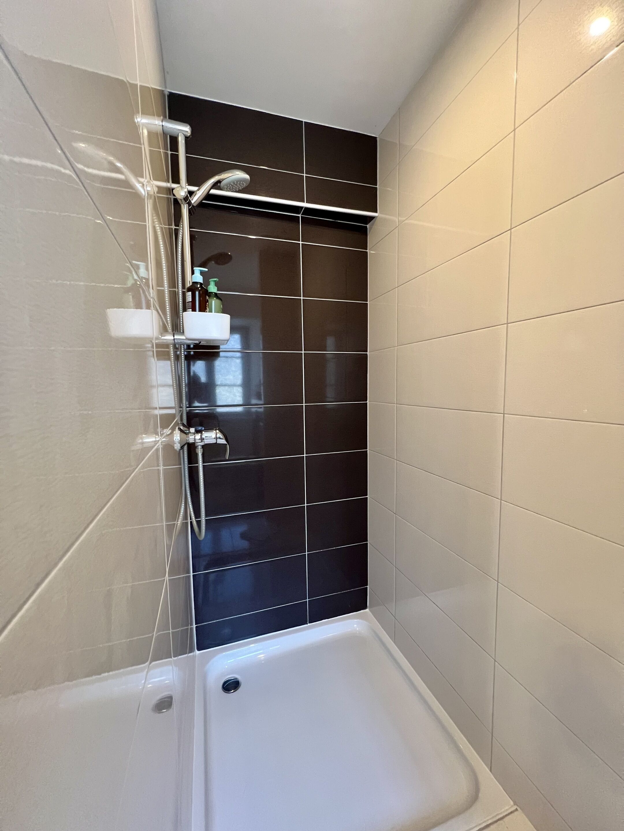 A bathroom with a shower, a toilet, and a sink.