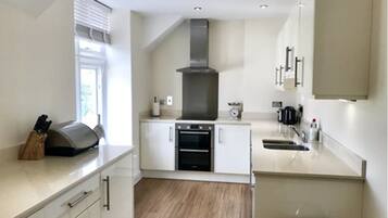 Apartment, 2 Bedrooms | Private kitchen | Full-size fridge, dishwasher, cookware/dishes/utensils