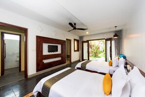 A hotel room with two beds, a TV, a ceiling fan, and a view of the outdoors. - Charming Angkor Resort & Spa (Siem Reap)