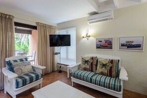 Habitación triple económica | Área de sala de estar | Televisión 