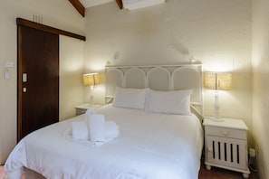 Cozy retreat with a large bed, bedside tables, and soft lighting.