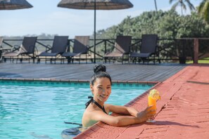 Relax by the pool with lounge chairs and umbrellas at your fingertips.