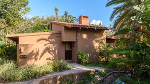 A modern house with a flat roof, a small porch, and a garden with a water feature. - San Lameer Villa Rentals 3404 (Southbroom)