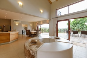 Relax in a spacious interior with a comfortable seating area, kitchenette, dining space, and balcony with outdoor seating.