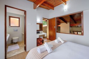 A bedroom with a bed, a bathroom with a toilet and sink, and a mirror. - San Lameer Villa Rentals 3506 (Southbroom)