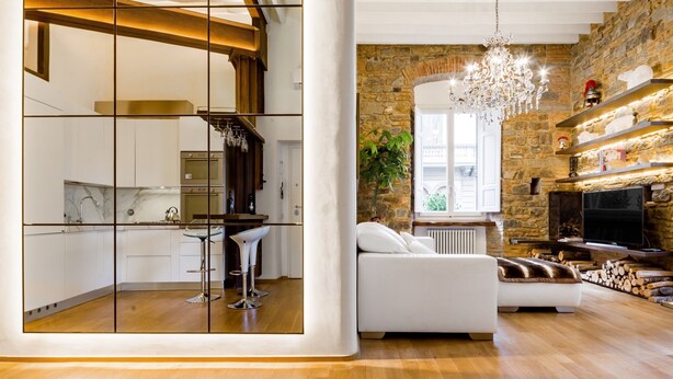A modern living space with a kitchen, a dining area, and a seating area with a fireplace. - Luxury 2 Bedroom Apartment with Hot Tub - Florence City Center (Florence)