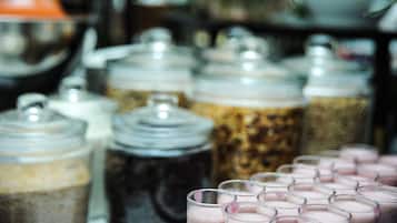 A variety of beverage dispensers, including milkshakes and iced drinks, in a commercial setting.