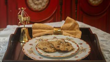 A tray with a plate of cookies and a decorative bow.