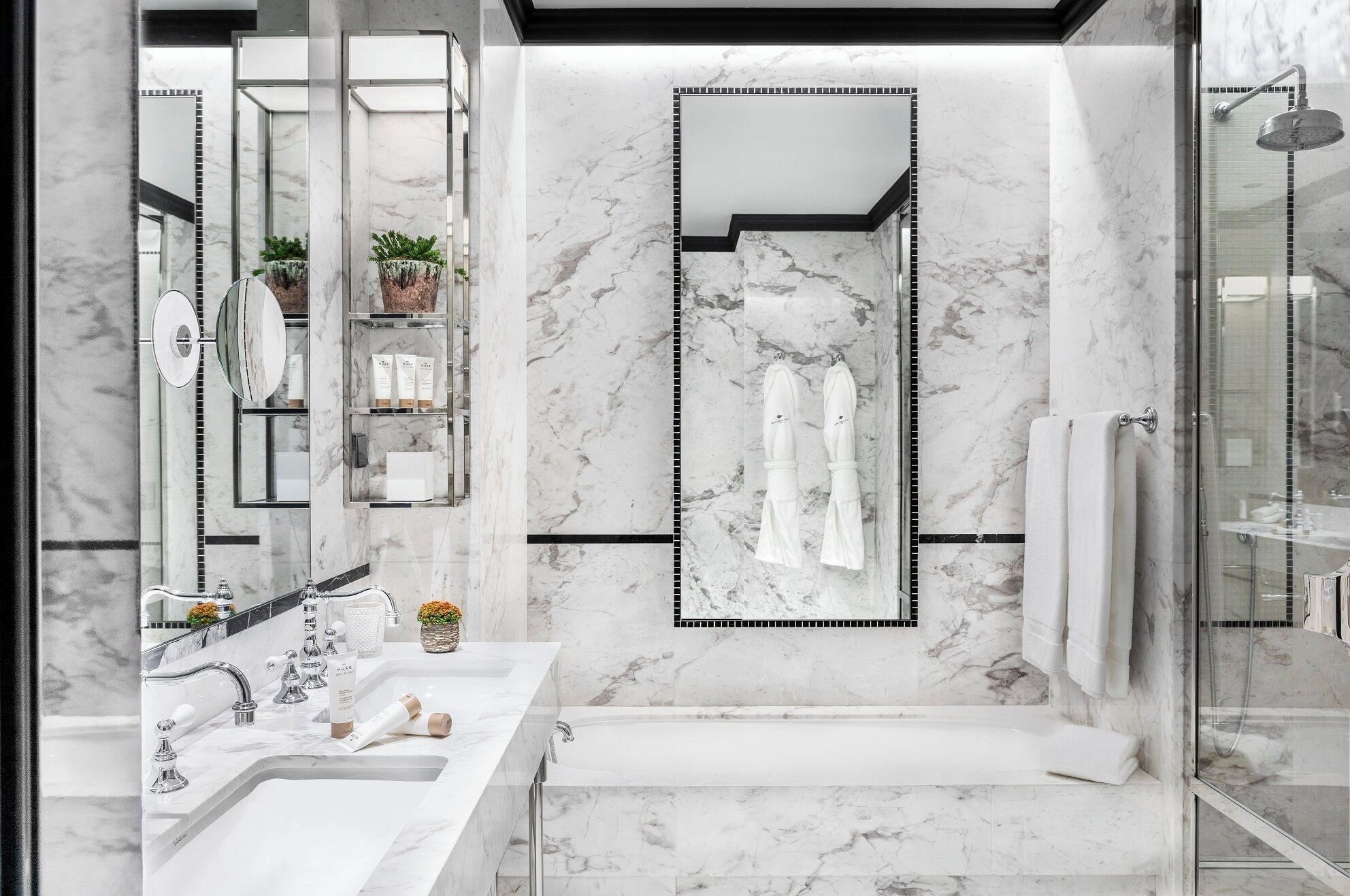 A modern bathroom with a large mirror, a bathtub, and a shower.