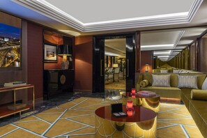 A luxurious hotel lobby with a marble floor, a round coffee table, a sofa, and a view of the Eiffel Tower through a large window. - The One Monumental Palace (Porto)