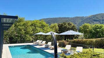 Seasonal outdoor pool, open 8:00 AM to 8:00 PM, pool loungers