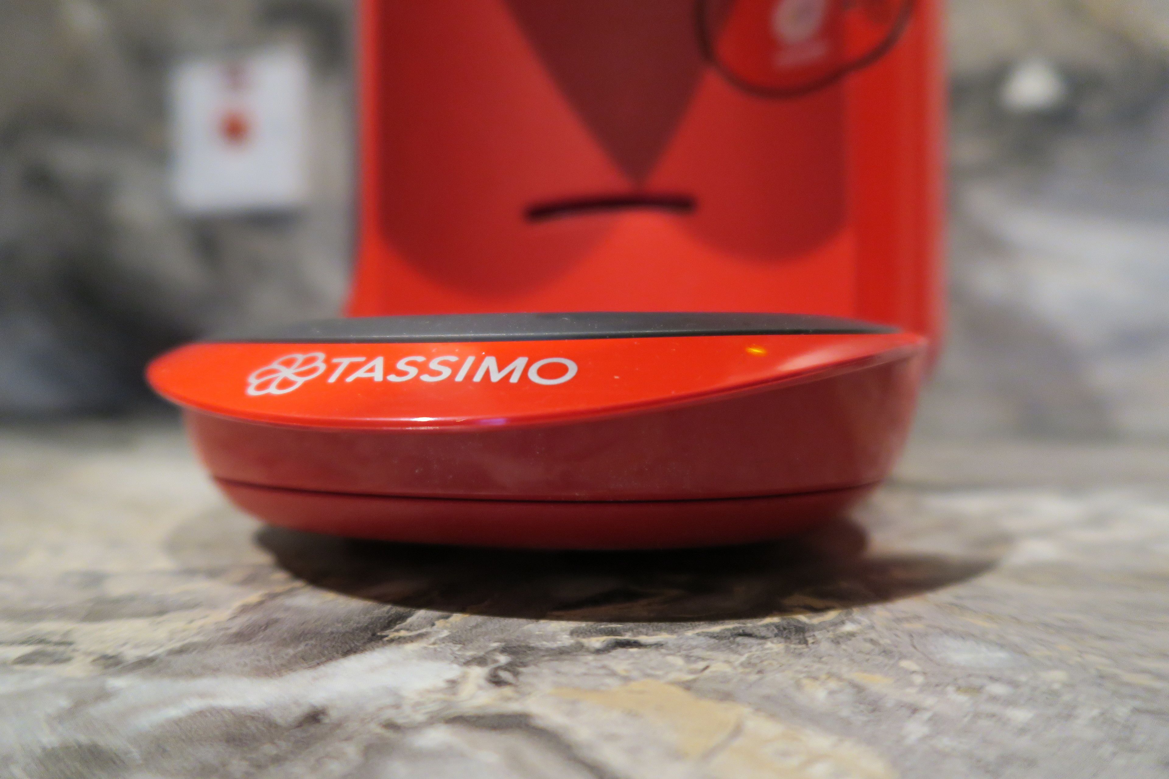 A red object with the word "TASSIMO" on it.