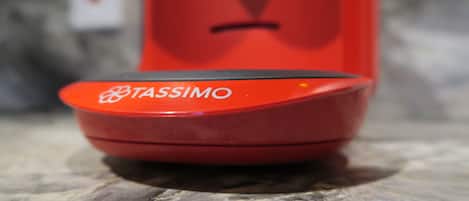 A red object with the word "TASSIMO" on it.