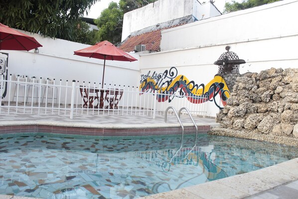 Outdoor pool, open 6 AM to 6 PM, pool umbrellas