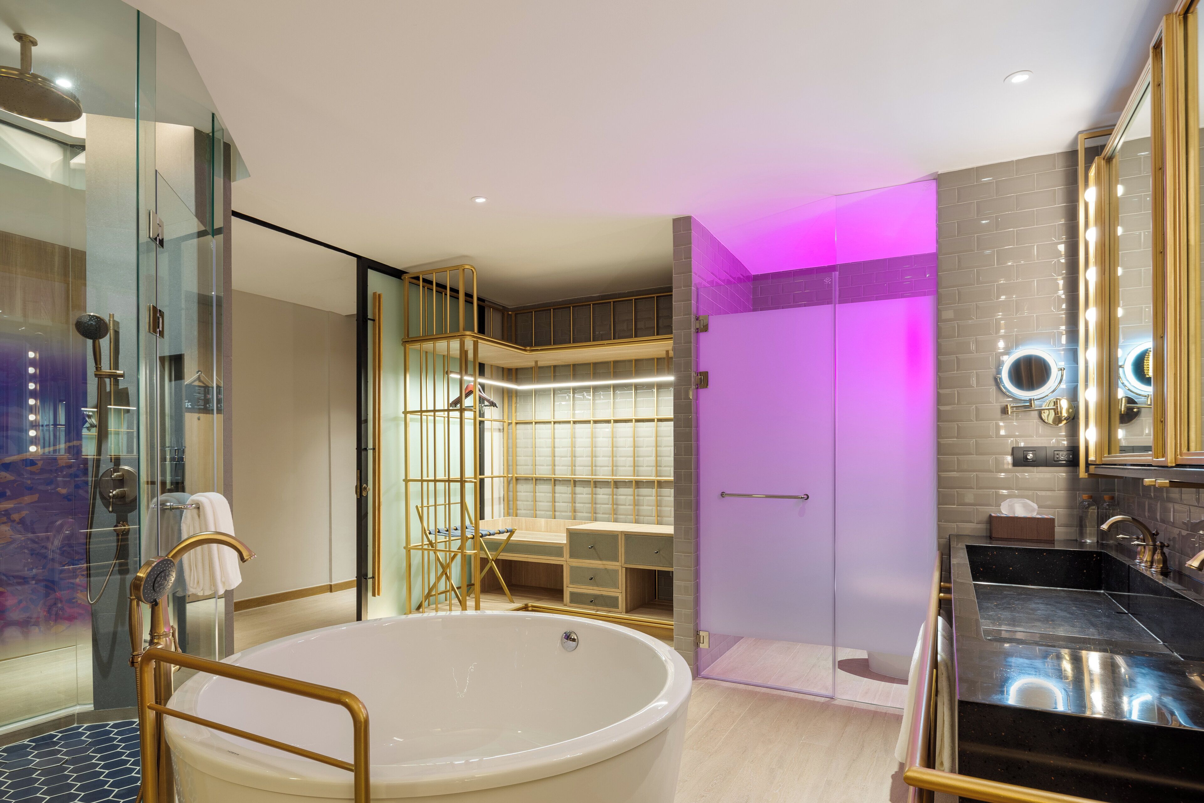 A modern bathroom with a freestanding bathtub, a glass shower enclosure, and a vanity with a sink.