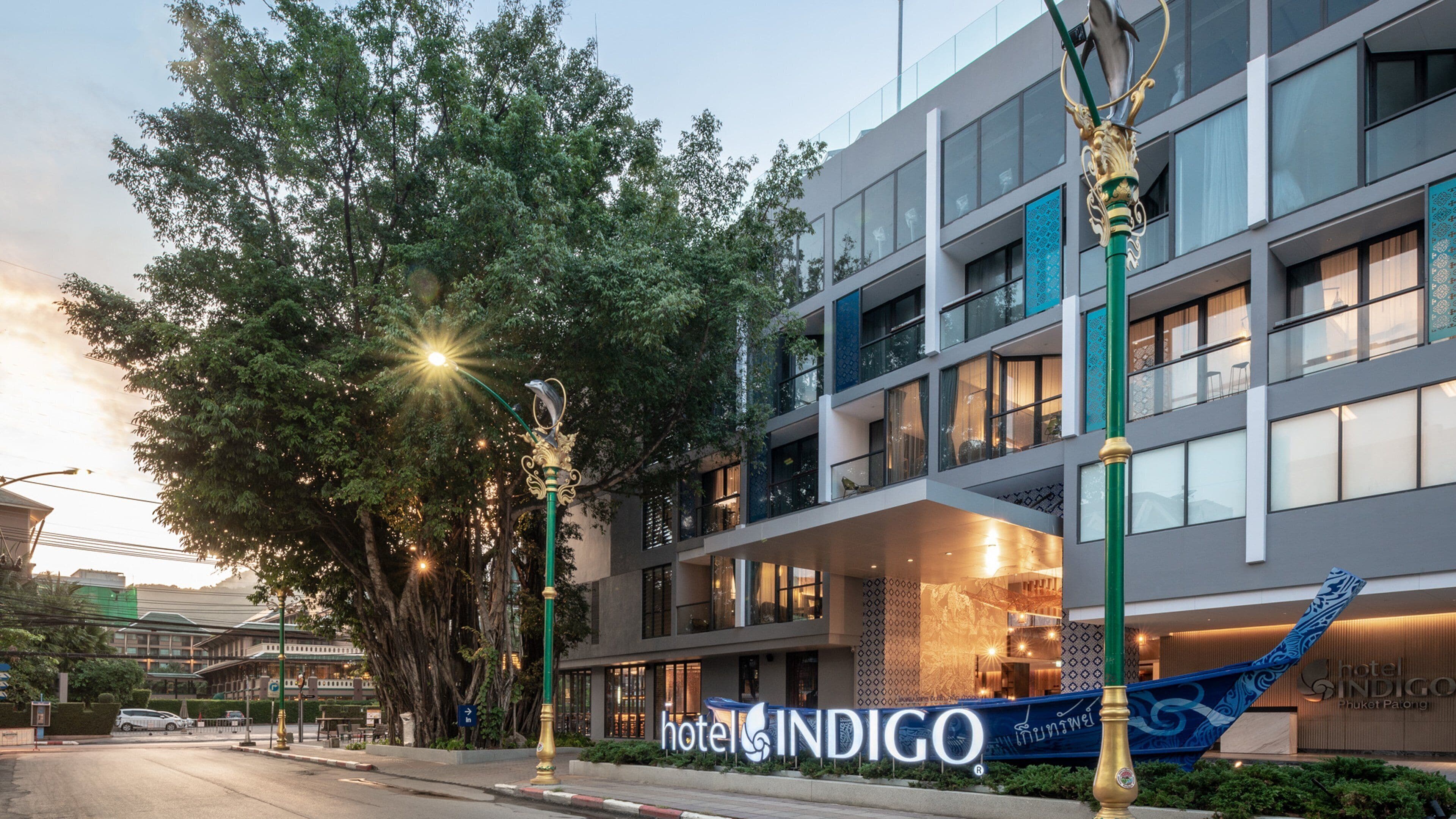 A modern hotel building with a sign reading "Hotel Indigo."