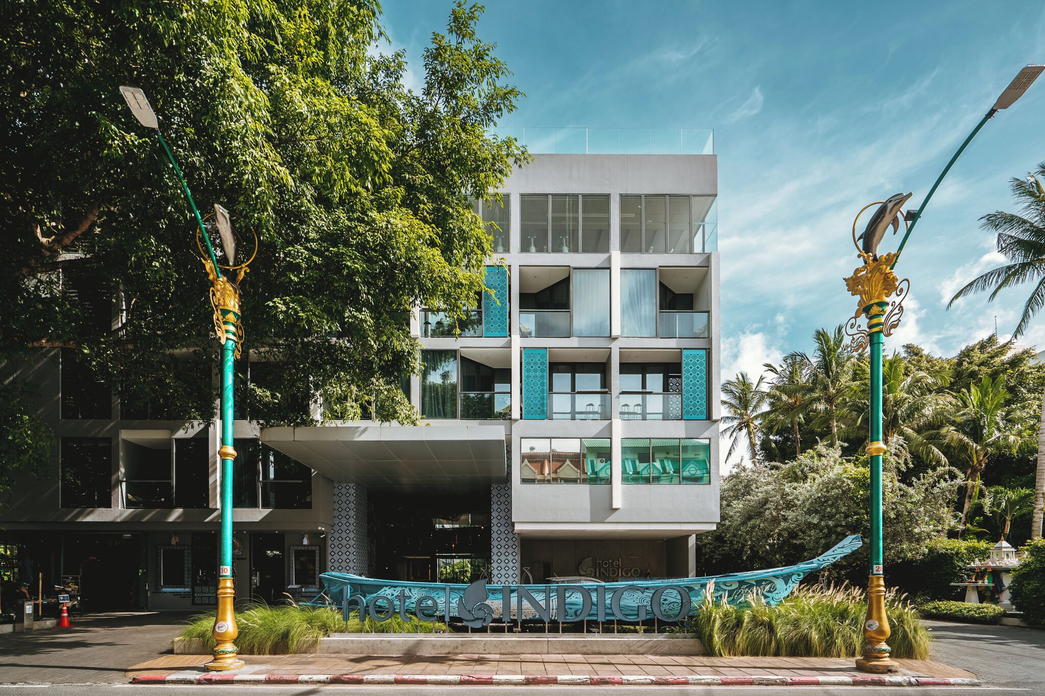 A modern hotel with a multi-story structure, large windows, and a prominent entrance.