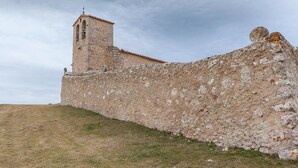 A stone wall with a bell tower, likely part of a historical building. - Hostal Hostatgeria Sant Jaume (La Pobla de Benifassa)