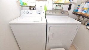Eine kompakte, weiße Wasch- und Trockner-Kombination mit Bedienfeld oben.
