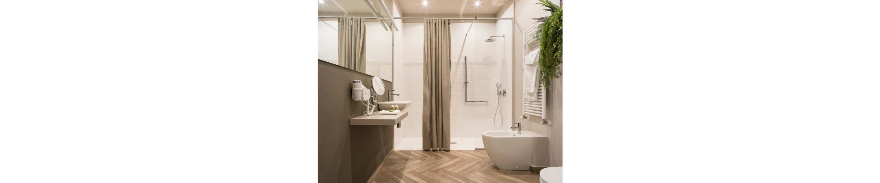 A modern bathroom with a shower, a sink, and a toilet.