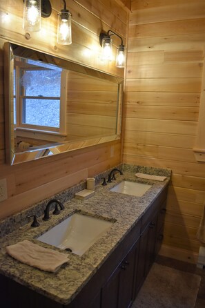 A wooden cabin bathroom with two sinks, a large mirror, and a window. - Private Log Cabin with an AMAZING VIREW!!!  Hot Tub and Sleeps up to 14 (Gilead)