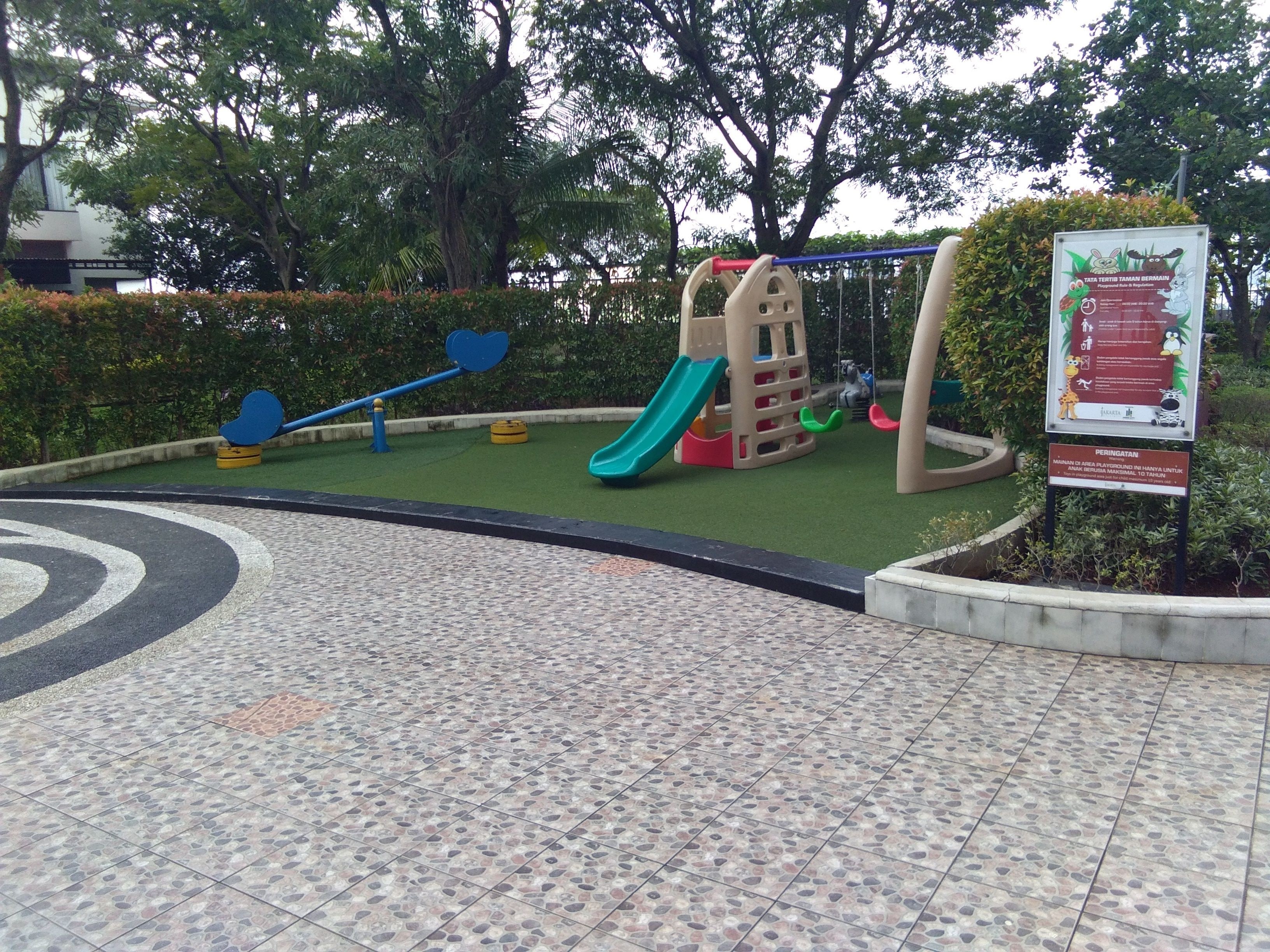 A playground with a slide, swings, and a climbing structure.