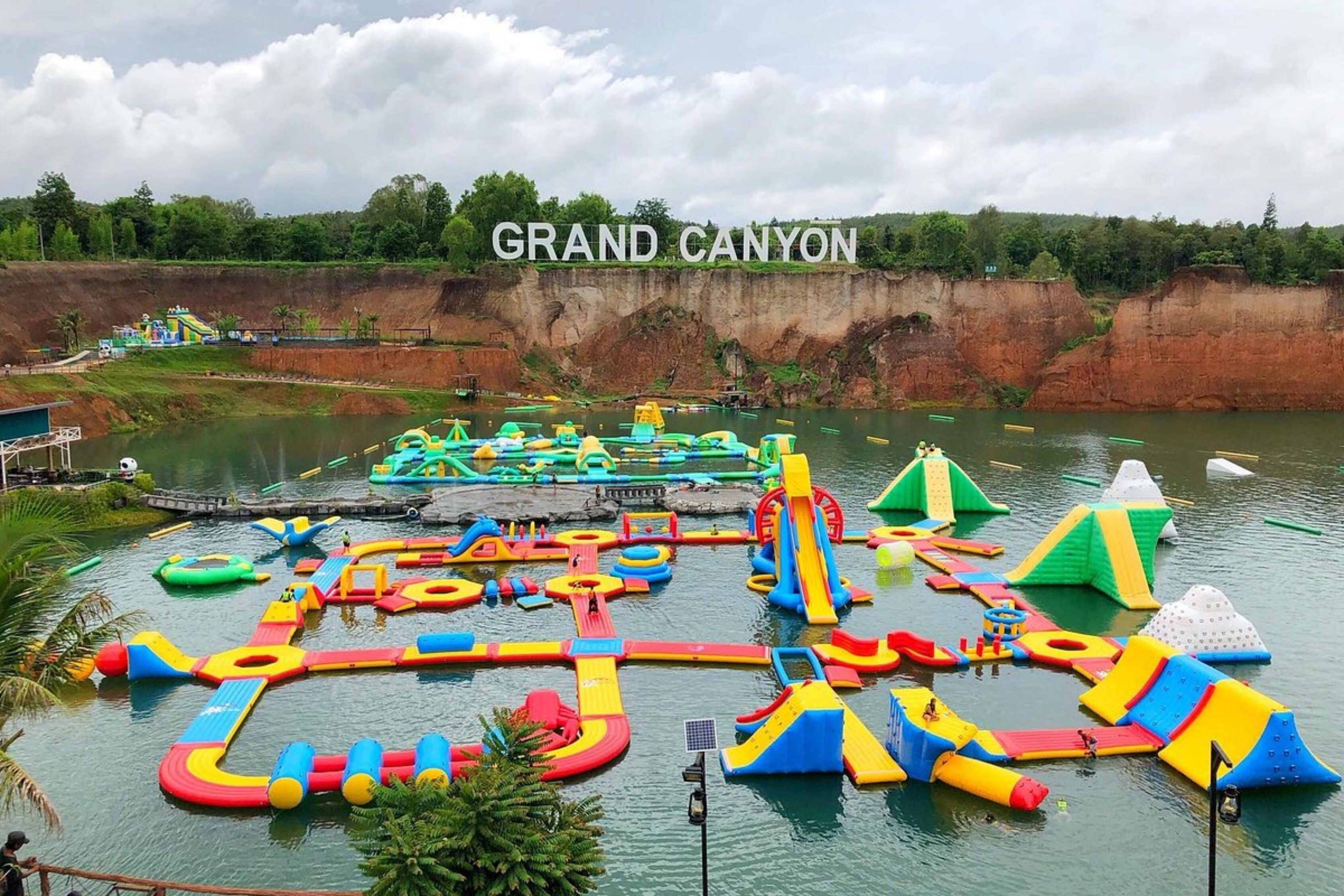 A water park with various inflatable play structures and slides.
