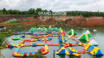 A water park with various inflatable play structures and slides.