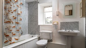 A bathroom with a bathtub, toilet, and sink, all in white.